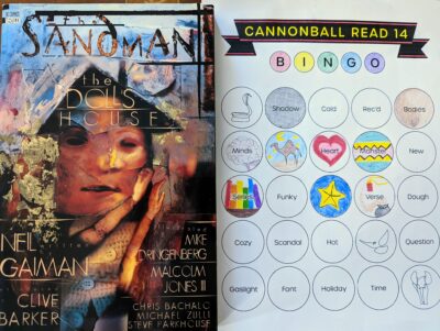 The graphic novel, "The Doll's House" written by Neil Gaiman next to a book bingo card.