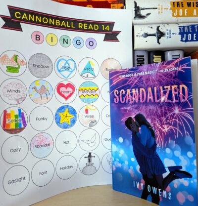 The book, "Scandalized" by Ivy Owens next to a book bingo card.