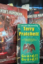 The book, "Guards! Guards!" by Terry Pratchett standing in front of the Dungeons and Dragons Player's Handbook and Monster Manual.