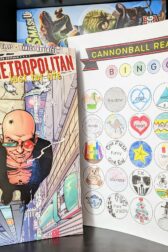 The graphic novel, "Transmetropolitan: Lust for Life" by Warren Ellis and others standing next to a completely filled out bingo card.