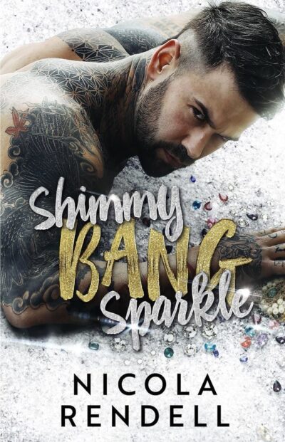 A bare chested white man shown from the shoulders up lies horizontally across the upper 2/3 of the cover on a bed of diamonds and gems. Ge is heavily tattooed with a short, neat beard and mustache and short dark brown hair. He is looking intently at the viewer. The title, Shimmy Bang Sparkle, is written in big sparkly cursive font.