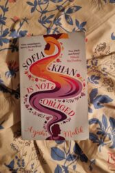 Cover of Sofia Khan is Not Obliged. It's a silhouette of a woman with a floating headscarf.