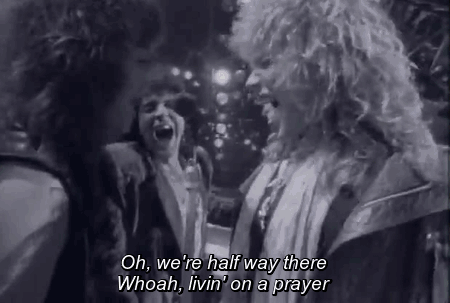 Gif of Bon Jovi members singing “oh, we’re half way there. Whoa, livin’ on a prayer.”